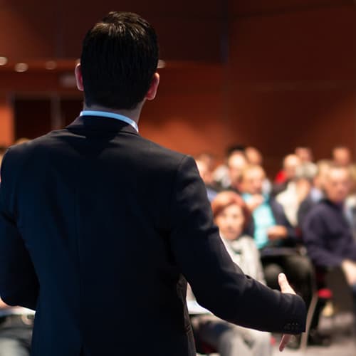 Man conducting training to room of people